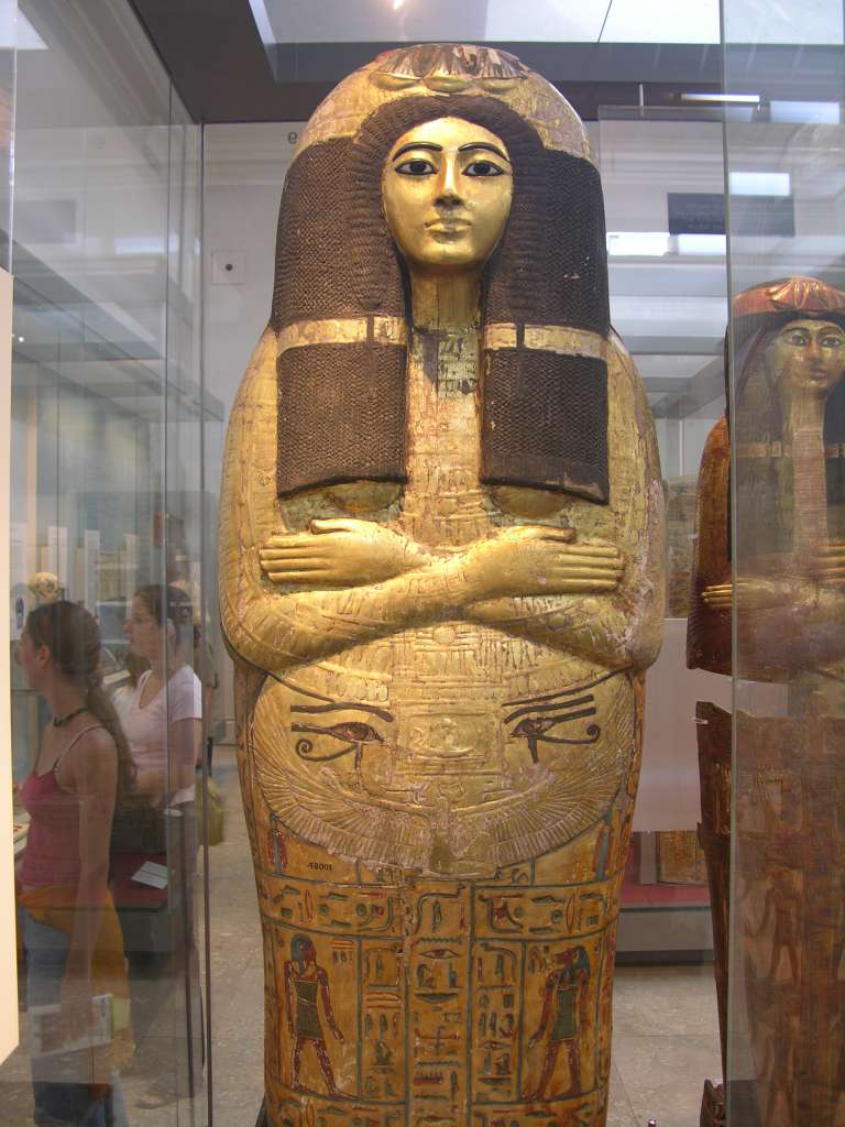 British Museum Top 20 16 Henutmehyt Gilded Outer Coffin 16 Henutmehyt Gilded Outer Coffin - Thebes Egypt, around 1250 BC, 46cm x 187cm. The coffin of Henutmehyt was human-shaped, which was believed to provide the spirit with a substitute body if the mummy should perish. The outer wooden coffin covered with gold leaf provides an idealized image of the dead woman, adorned with her full wig. A collar is spread over the breast, and below it hangs a pectoral (chest) ornament flanked by protective wedjat eyes. The sky-goddess Nut spreads her winged arms protectively across the body, and the hieroglyphic text immediately below invokes her. Vertical and horizontal bands divide the remainder of the lid into compartments which are occupied by figures of the Sons of Horus and the goddesses Isis and Nephthys.